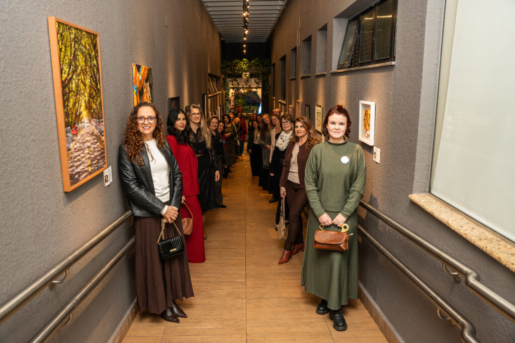 Arte, cultura e raízes locais: o Nadai é ponto de encontro entre hospitalidade e identidade 1 Grupo de mulheres em corredor artístico, do hotel Nadai.